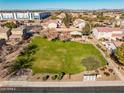 Community park with grassy area, playground, and shaded seating at 8766 W Desert Trl, Peoria, AZ 85381