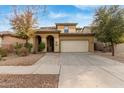 Tan two-story house with a two-car garage and nicely landscaped front yard at 8841 W Cordes Rd, Tolleson, AZ 85353