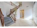 Two-story entryway with staircase and tile flooring at 10406 E Laguna Azul Ave, Mesa, AZ 85209