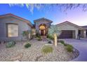 Desert home exterior, featuring a large front yard and three-car garage at 12657 N 135Th St, Scottsdale, AZ 85259