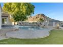 Relaxing backyard oasis with a freeform pool and mountain views at 1604 E Sheena Dr, Phoenix, AZ 85022