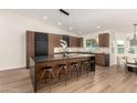 Modern kitchen featuring island, stainless steel appliances, and hardwood floors at 16446 N 56Th Way, Scottsdale, AZ 85254