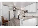 Modern kitchen with white cabinets, stainless steel appliances, and L-shape counter at 1724 W 15Th Ave, Apache Junction, AZ 85120