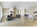 Bright and airy living room featuring a fireplace and large windows at 18903 N 87Th Dr, Peoria, AZ 85382