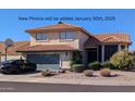 Two-story house with tile roof, attached garage, and basketball hoop at 19222 N 70Th Ave, Glendale, AZ 85308