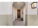 Inviting entryway with arched doorways and a wooden front door at 19961 W Heatherbrae Dr, Litchfield Park, AZ 85340