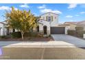 Two-story house with a landscaped front yard and attached garage at 19961 W Heatherbrae Dr, Litchfield Park, AZ 85340