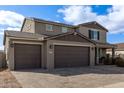 Two-story house with brown garage doors and landscaping at 2071 E Piedmont Pl, Casa Grande, AZ 85122