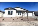 White house with gray accents, landscaping, and a two-car garage at 22910 E Alyssa Rd, Queen Creek, AZ 85142