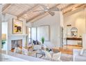 Spacious living room featuring a fireplace, high ceilings, and lots of natural light at 3117 E Sierra Madre Way, Phoenix, AZ 85016