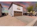 Two-story house with a brown garage door and driveway, desert landscape in the background at 3234 S Bowman Rd, Apache Junction, AZ 85119