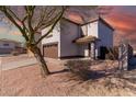 Two-story house with brown garage door and landscaping, desert landscape in the background at 3234 S Bowman Rd, Apache Junction, AZ 85119