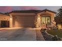 Single-story home with a two-car garage, nicely landscaped front yard, and desert landscaping at 337 W Stanley Ave, San Tan Valley, AZ 85140