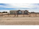 Tan and dark brown single-story house with a gated fence at 36747 W Harrison St, Tonopah, AZ 85354