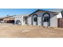 White single story home with arched entryway and landscaping at 3744 W Malapai Dr, Phoenix, AZ 85051