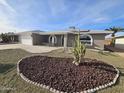 Front yard view showcasing a single-story home with a desert landscape and a cactus at 4054 E Clovis Cir, Mesa, AZ 85206