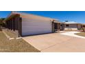 A well-maintained two-car garage with a large driveway provides ample parking at 4054 E Clovis Cir, Mesa, AZ 85206