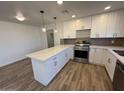 Modern kitchen with white cabinets, stainless steel appliances and quartz countertops at 4062 W Camino Acequia St, Phoenix, AZ 85051