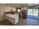 Modern kitchen with white cabinets, stainless steel appliances, and quartz countertops at 4062 W Camino Acequia St, Phoenix, AZ 85051