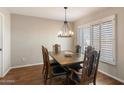 Formal dining room with a wood table, six chairs, and a chandelier at 4421 W Laurie Ln, Glendale, AZ 85302