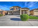 Two-story house with a three-car garage and lush green landscaping at 46107 W Morning View Ln, Maricopa, AZ 85139