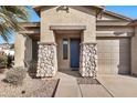 Front entrance with blue door, stone pillars, and walkway at 6229 S Moccasin Trl, Gilbert, AZ 85298