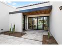 Outdoor courtyard with modern design, tile flooring, and connection to interior spaces at 8255 E Morgan Trl, Scottsdale, AZ 85258