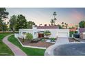 Stunning, modern home with a tile roof, desert landscaping, and a circular driveway at 8255 E Morgan Trl, Scottsdale, AZ 85258
