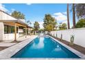 Refreshing pool surrounded by patio area and landscaping, creating a private backyard oasis at 8255 E Morgan Trl, Scottsdale, AZ 85258