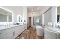 Luxurious bathroom with double vanities, a soaking tub, and a walk-in shower at 8277 E Tailspin Ln, Scottsdale, AZ 85255