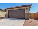 Two-car garage with decorative door at 8569 N 175Th Ln, Waddell, AZ 85355