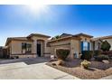 House exterior showcasing a two-car garage and desert landscaping at 8805 W Windrose Dr, Peoria, AZ 85381