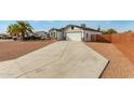 Newly built home with a long driveway leading to the attached garage at 902 S 96Th St, Mesa, AZ 85208