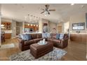 Spacious living room featuring a leather sectional sofa and hardwood floors at 10254 N Demaret Dr, Fountain Hills, AZ 85268