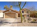 Charming single-story home with a two car garage, xeriscaped front yard and beige exterior at 11825 S 46Th St, Phoenix, AZ 85044
