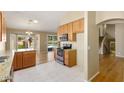 Open concept kitchen with stainless steel appliances and a view to the backyard pool at 11825 S 46Th St, Phoenix, AZ 85044