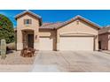 Charming single-story home featuring a three-car garage and desert landscaping at 13550 W Port Au Prince Ln, Surprise, AZ 85379