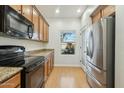 Modern kitchen with stainless steel appliances and wood cabinets at 1381 W Birch Rd, Queen Creek, AZ 85140