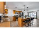 Bright kitchen featuring an island with bar seating, stainless steel appliances, and granite countertops, perfect for modern living at 1540 W Marco Polo Rd, Phoenix, AZ 85027