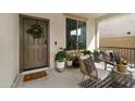 Inviting front porch with seating and potted plants at 17948 W Diana Ave, Waddell, AZ 85355