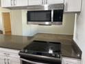 Stainless steel microwave and electric cooktop in updated kitchen at 1816 E Palmcroft Dr, Tempe, AZ 85282