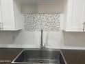 Grey hexagon backsplash and stainless steel sink in the updated kitchen at 1816 E Palmcroft Dr, Tempe, AZ 85282