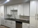 White shaker cabinets, granite countertops, and a stainless steel sink at 1816 E Palmcroft Dr, Tempe, AZ 85282