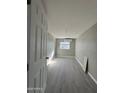 Simple bedroom with wood-look floors and a window at 245 S 56 St # 174, Mesa, AZ 85206
