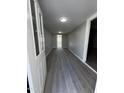 Long hallway with gray walls and wood-look floors at 245 S 56 St # 174, Mesa, AZ 85206