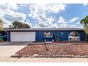 Blue brick ranch home with white garage door at 2643 E Boise St, Mesa, AZ 85213