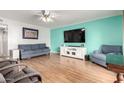 Living room with hardwood floors, teal walls, and comfy seating at 2643 E Boise St, Mesa, AZ 85213