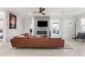 Living room with a brown leather couch and electric fireplace at 2826 N 28Th Pl, Phoenix, AZ 85008