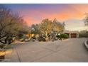 Home exterior with driveway, landscaping, and desert plants at 34587 N Ironwood Rd, Scottsdale, AZ 85266