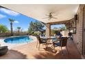 Covered patio featuring an outdoor seating area and view of the pool at 36448 N Wildflower Rd, Carefree, AZ 85377